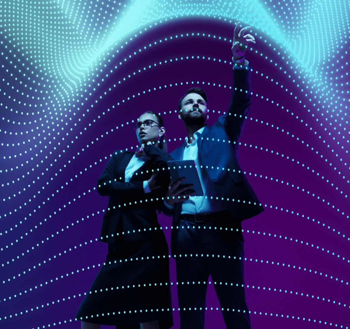 Two businesspeople pointing amid digital light waves